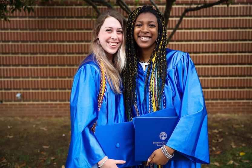 A group of graduates wearing blue robes
